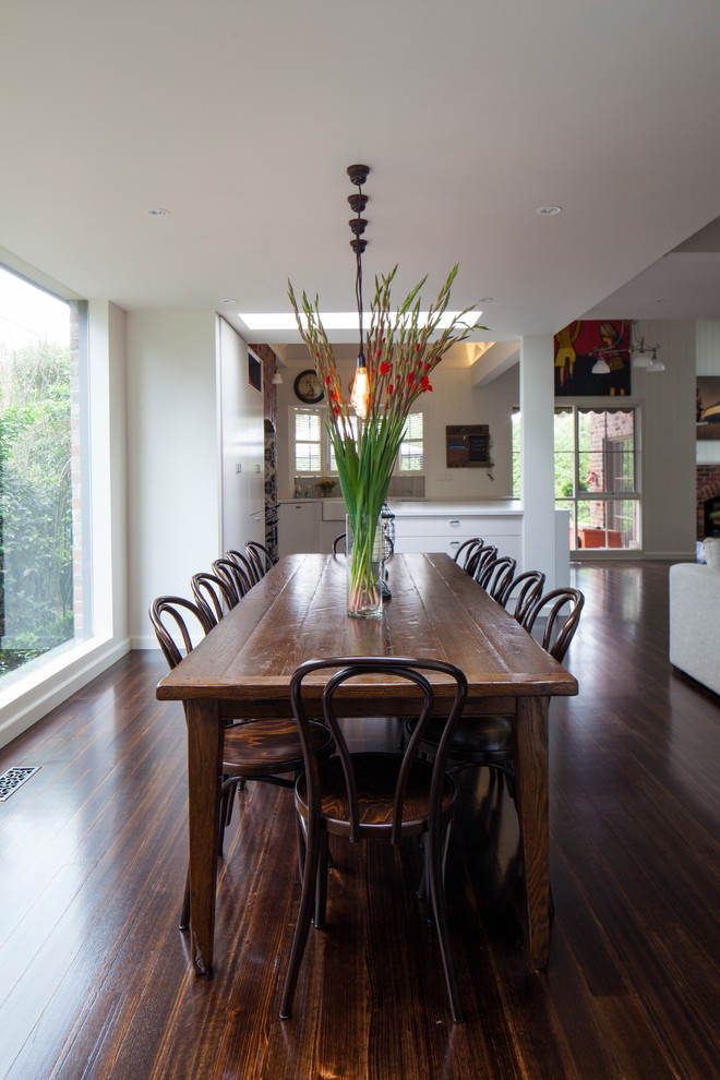 Photo of a large modern dining room in Melbourne with dark hardwood floors.