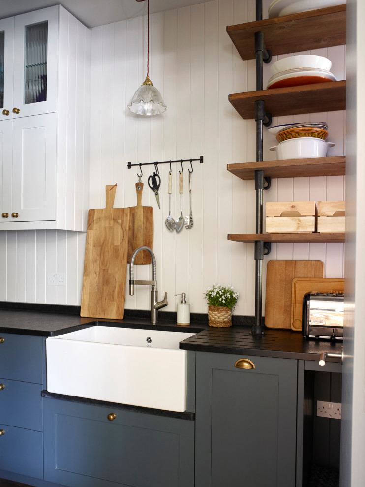 Photo of an eclectic open plan kitchen in London with with island.