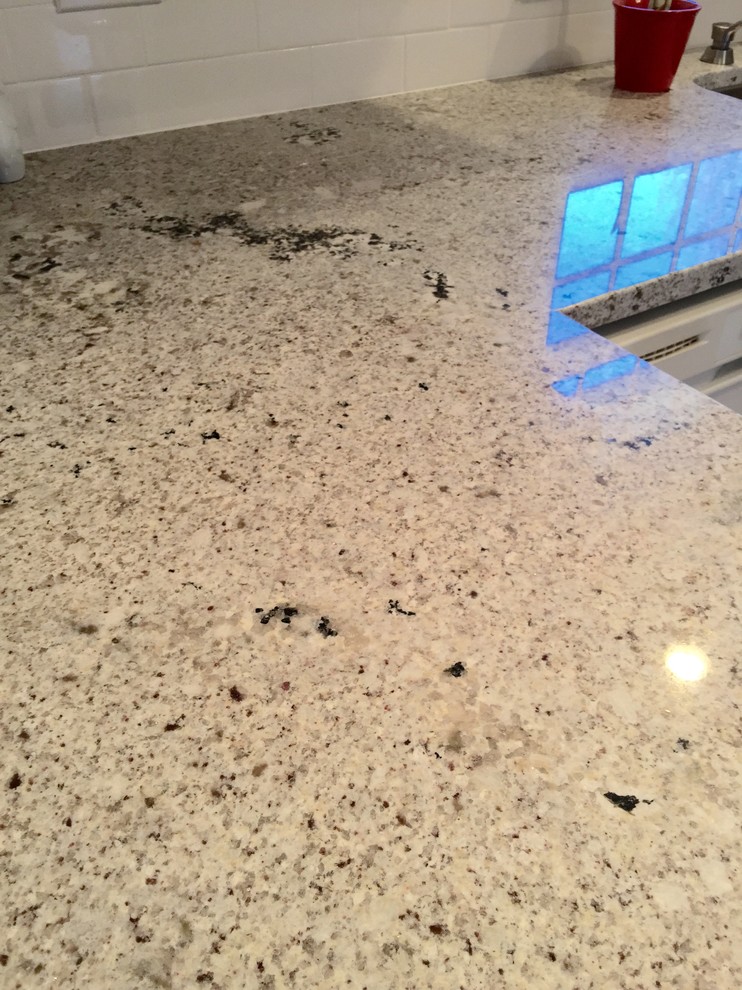 Mid-sized transitional u-shaped porcelain tile enclosed kitchen photo with an undermount sink, raised-panel cabinets, white cabinets, granite countertops, white backsplash, subway tile backsplash, stainless steel appliances and a peninsula