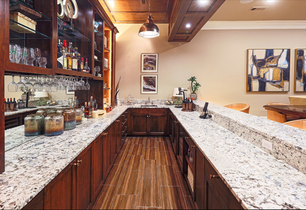 Photo of a large traditional galley wet bar in Dallas with open cabinets, medium wood cabinets, quartz benchtops, carpet, beige floor and beige benchtop.