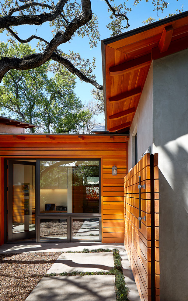 Small modern one-storey stucco exterior in Austin with a gable roof.