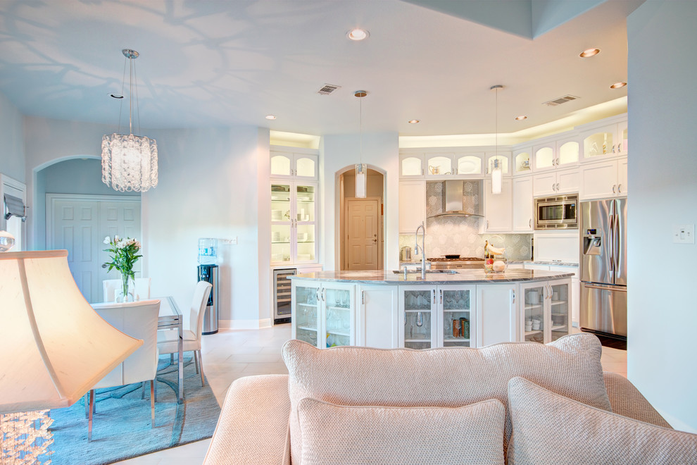 Example of a mid-sized transitional porcelain tile eat-in kitchen design in Austin with an undermount sink, recessed-panel cabinets, white cabinets, marble countertops, gray backsplash, mosaic tile backsplash and stainless steel appliances