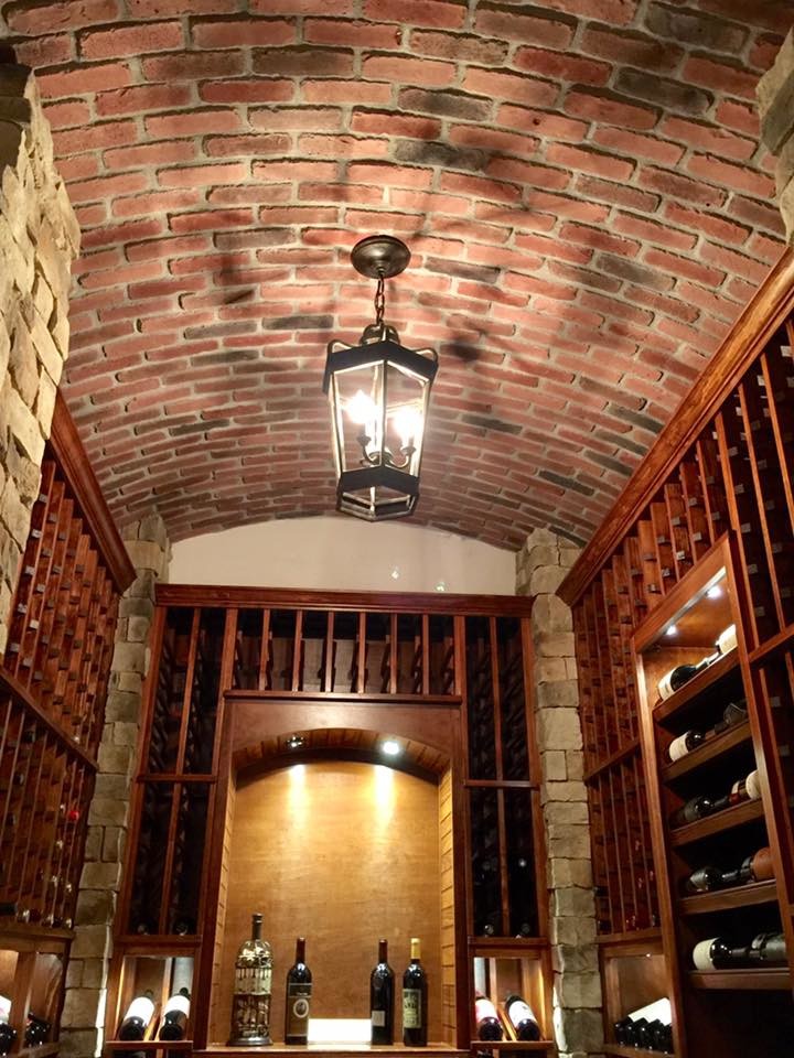 Design ideas for a large country wine cellar in Orange County with medium hardwood floors and diamond bins.