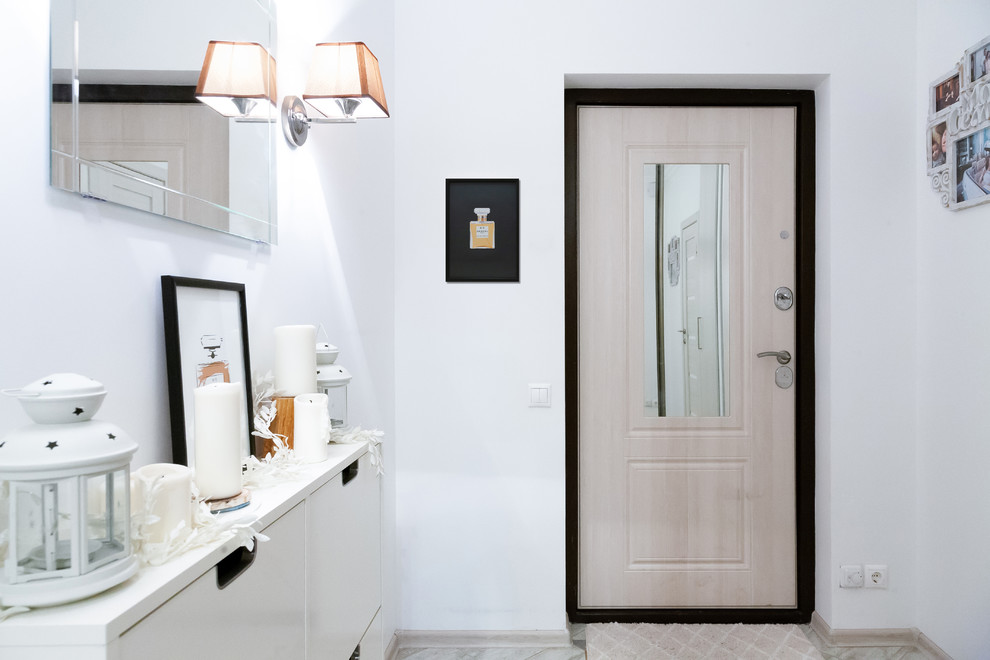 Inspiration for a small scandinavian front door in Moscow with white walls, porcelain floors, a single front door, a light wood front door and beige floor.