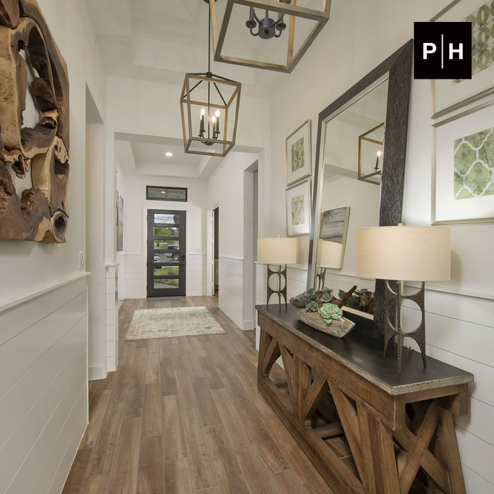 Entryway - medium tone wood floor, tray ceiling and shiplap wall entryway idea in Other with beige walls and a dark wood front door