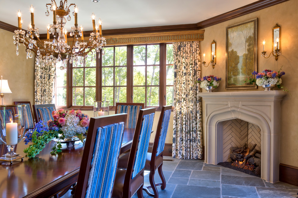 This is an example of a traditional separate dining room in Other with beige walls and a standard fireplace.