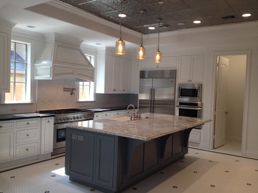 Design ideas for a large traditional l-shaped separate kitchen in Houston with a farmhouse sink, shaker cabinets, white cabinets, marble benchtops, white splashback, porcelain splashback, stainless steel appliances, ceramic floors, with island and white floor.
