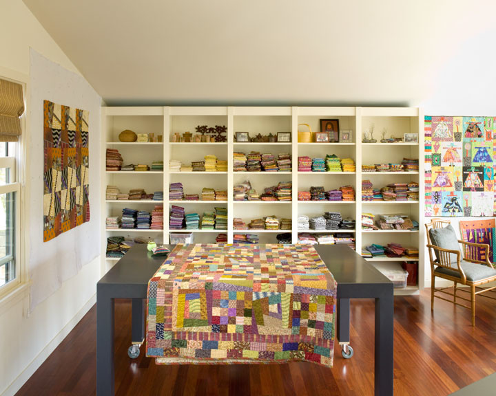 Large transitional craft room in San Francisco with white walls, light hardwood floors and a freestanding desk.