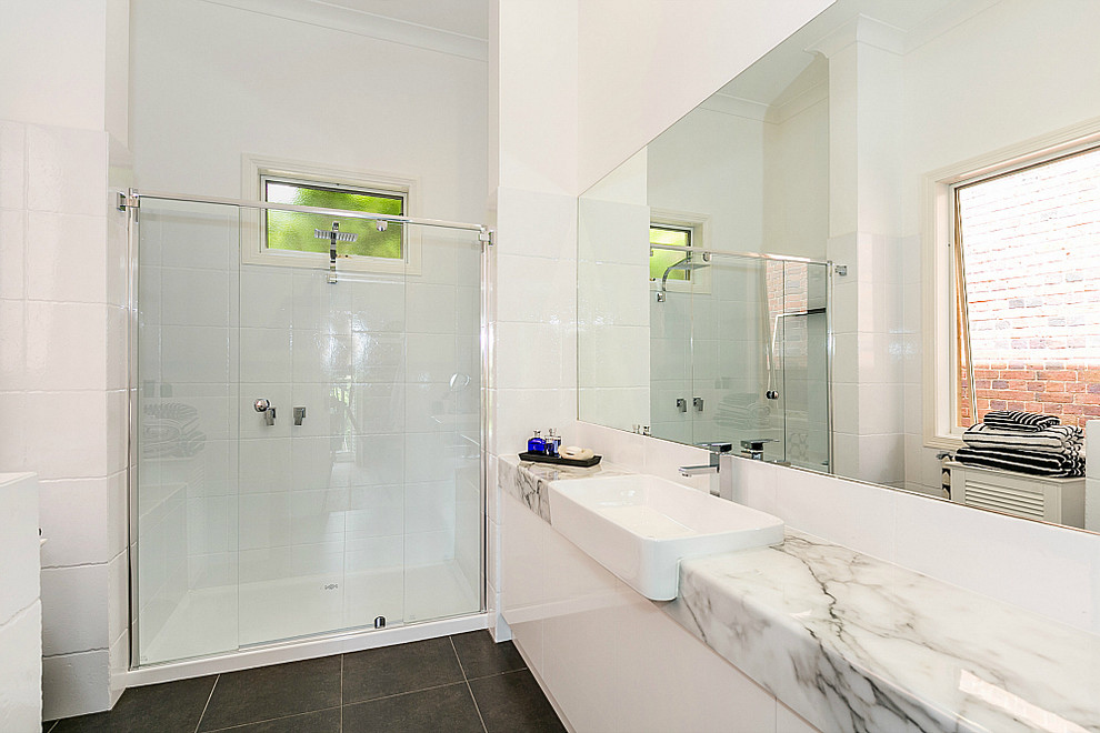 Design ideas for a mid-sized contemporary master bathroom in Geelong with a vessel sink, flat-panel cabinets, marble benchtops, white tile, white walls and ceramic floors.