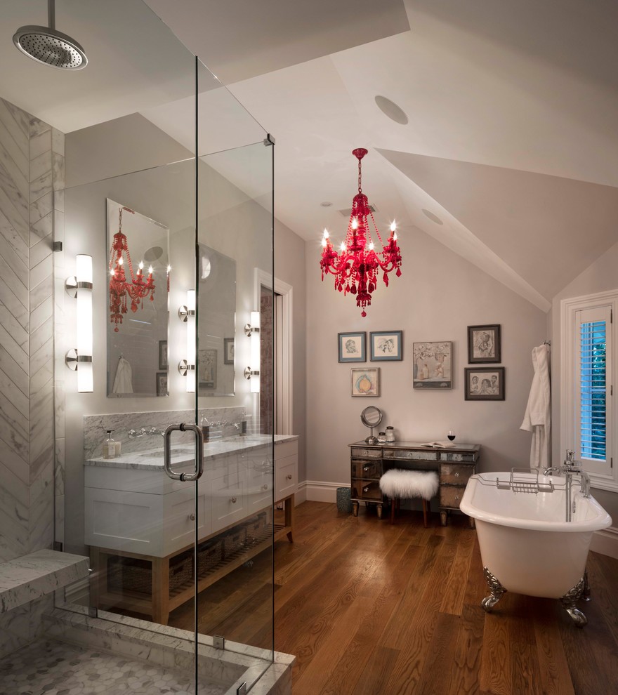 Inspiration for a transitional bathroom in Denver with shaker cabinets, white cabinets, a claw-foot tub, a corner shower, gray tile, mosaic tile, grey walls, medium hardwood floors, an undermount sink, brown floor, a hinged shower door and grey benchtops.