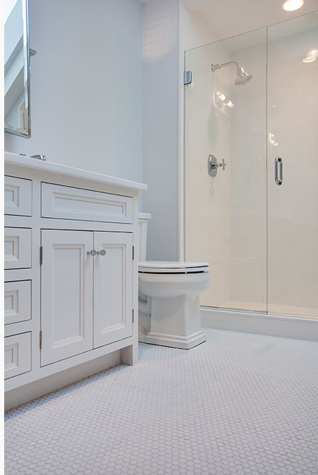Alcove shower - large transitional white floor alcove shower idea with recessed-panel cabinets, white cabinets, white walls, an undermount sink and a hinged shower door