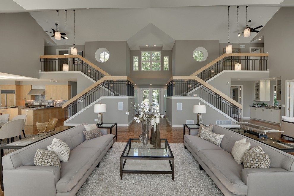 Expansive contemporary open concept living room in Minneapolis with grey walls.