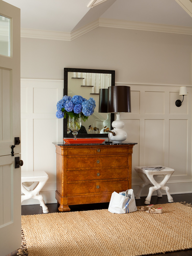 Inspiration for a mid-sized transitional foyer in New York with white walls and dark hardwood floors.