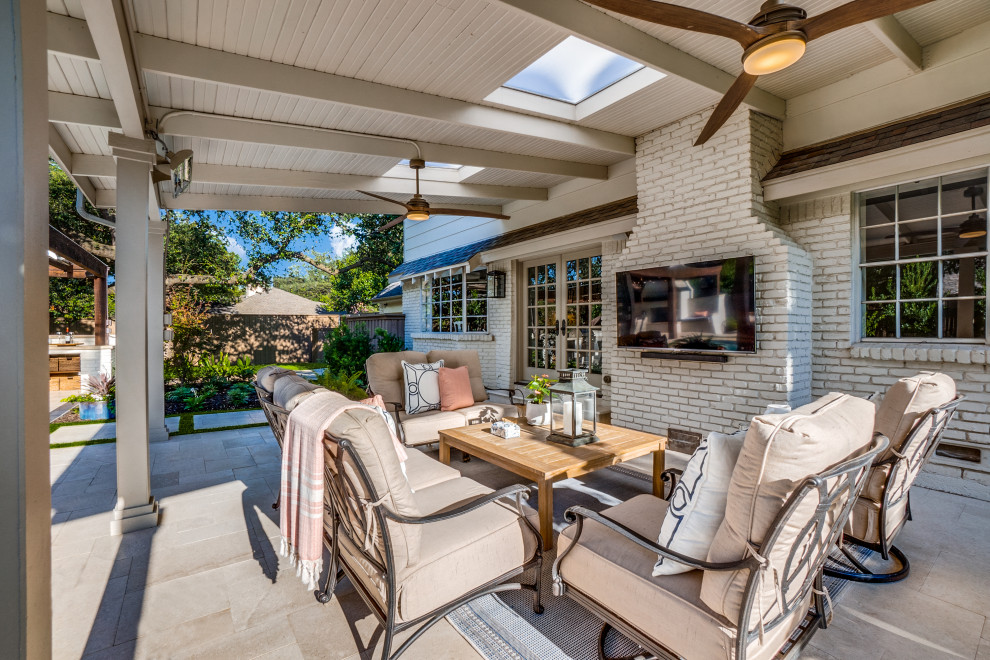 Photo of an expansive eclectic backyard patio in Dallas with with fireplace and a pergola.