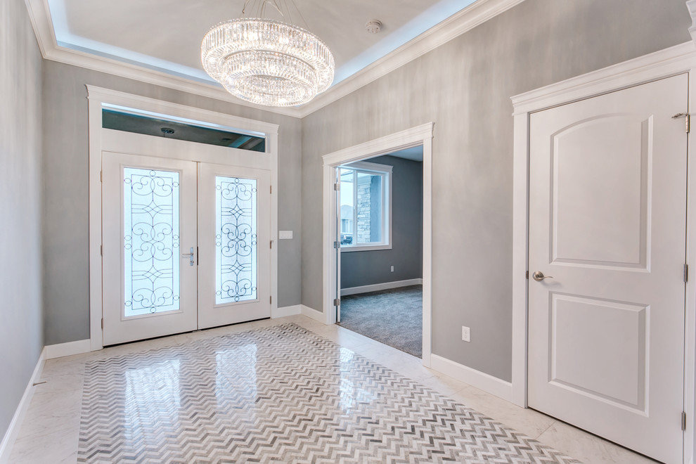 Inspiration for a large transitional marble floor and white floor entry hall remodel in Seattle with gray walls and a white front door