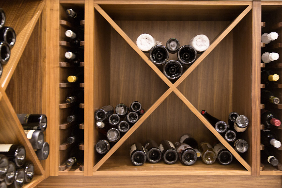 Small transitional wine cellar photo in Vancouver with medium tone wood cabinets