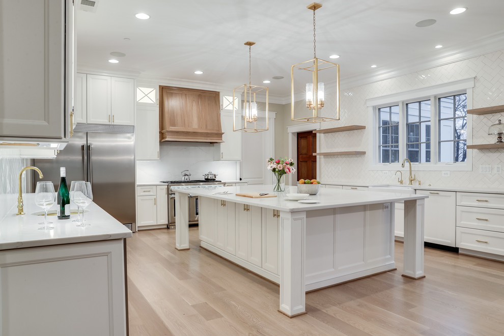 Kitchen - huge transitional kitchen idea in Baltimore with flat-panel cabinets, white cabinets, marble countertops, white backsplash, subway tile backsplash, stainless steel appliances and an island