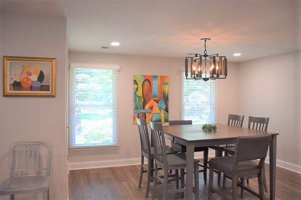 Mid-sized transitional medium tone wood floor great room photo in Baltimore with gray walls and no fireplace