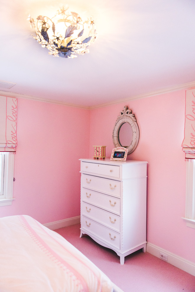 Photo of a mid-sized transitional kids' bedroom for kids 4-10 years old and girls in New York with pink walls, carpet and pink floor.