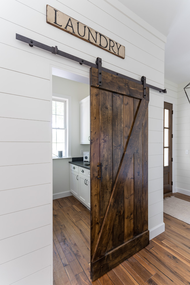 Example of a cottage laundry room design in Raleigh