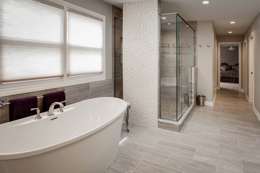 Freestanding bathtub - large transitional master brown tile, beige tile and porcelain tile porcelain tile and beige floor freestanding bathtub idea in Chicago with raised-panel cabinets, white cabinets, beige walls, an undermount sink, granite countertops, a hinged shower door and beige countertops