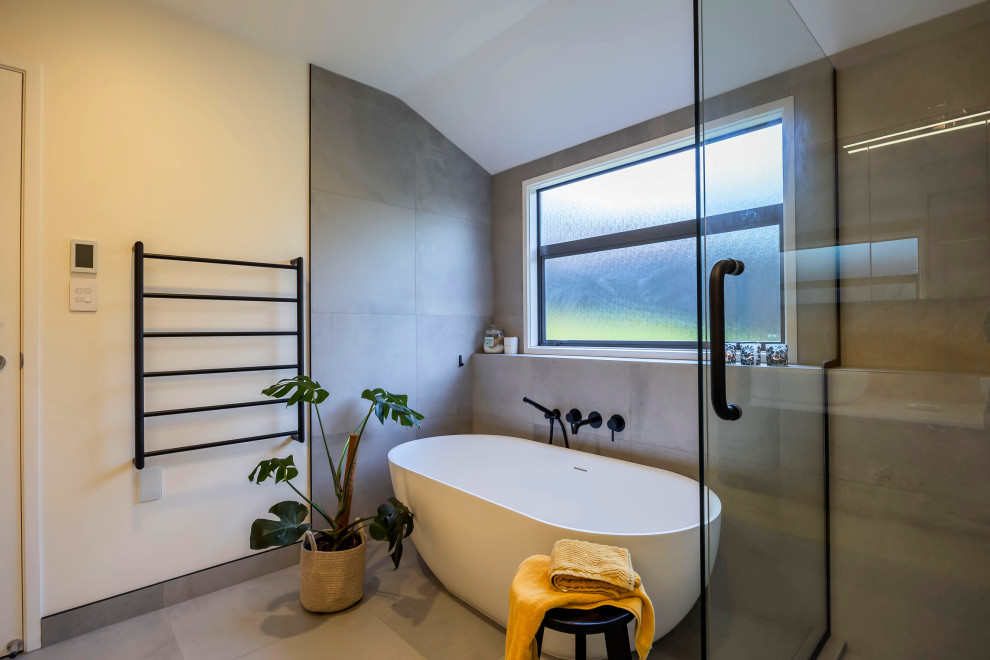 Freestanding bathtub - mid-sized contemporary kids' gray tile and ceramic tile freestanding bathtub idea in Auckland