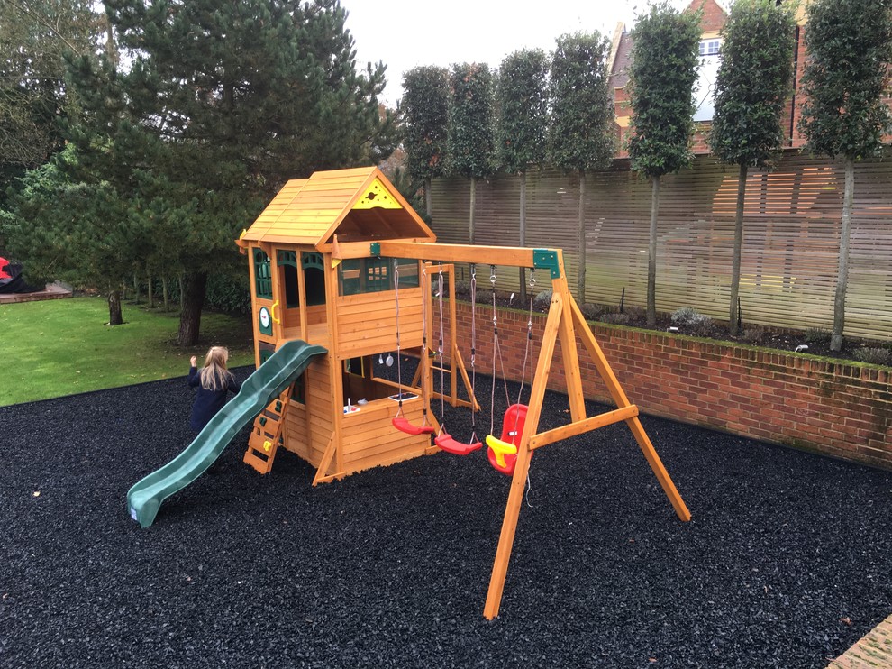 Inspiration for a large contemporary backyard garden in Buckinghamshire with with outdoor playset.