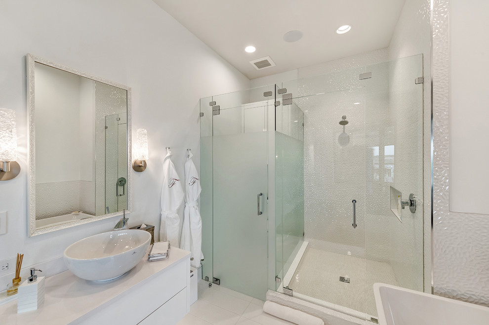 Mid-sized contemporary master bathroom in Orange County with flat-panel cabinets, white cabinets, a freestanding tub, an open shower, a one-piece toilet, white tile, marble, white walls, marble floors, an undermount sink, engineered quartz benchtops, white floor and a hinged shower door.