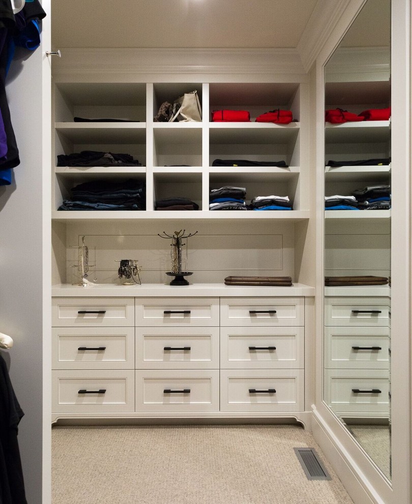 Large traditional gender-neutral walk-in wardrobe in Calgary with open cabinets, white cabinets and carpet.