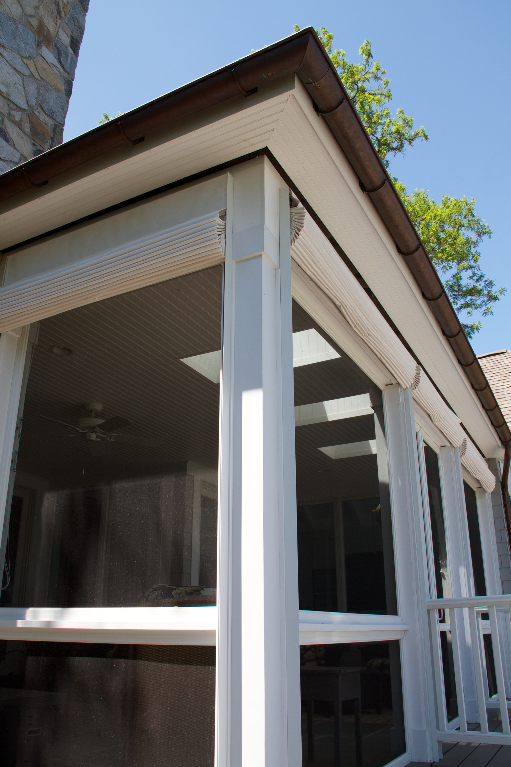 Outdoor shades lift from inside screen porch.