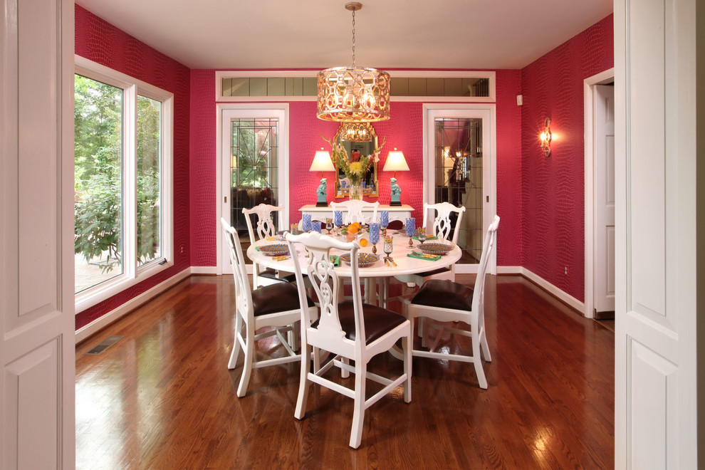 Design ideas for a modern dining room in Louisville with pink walls and medium hardwood floors.