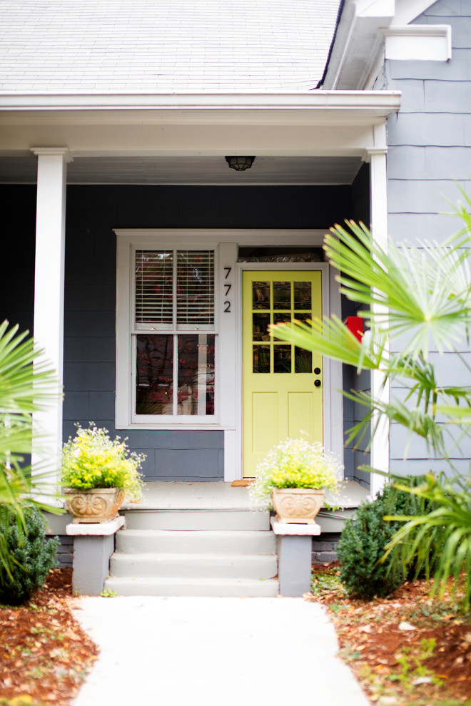 Mid-sized traditional front door in Atlanta with blue walls, a single front door, a yellow front door and beige floor.