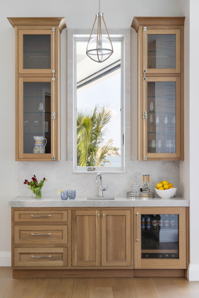Example of a beach style home bar design in Tampa