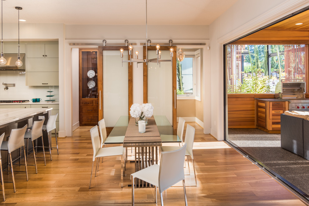 Inspiration for a large contemporary kitchen/dining combo in Portland with white walls and light hardwood floors.