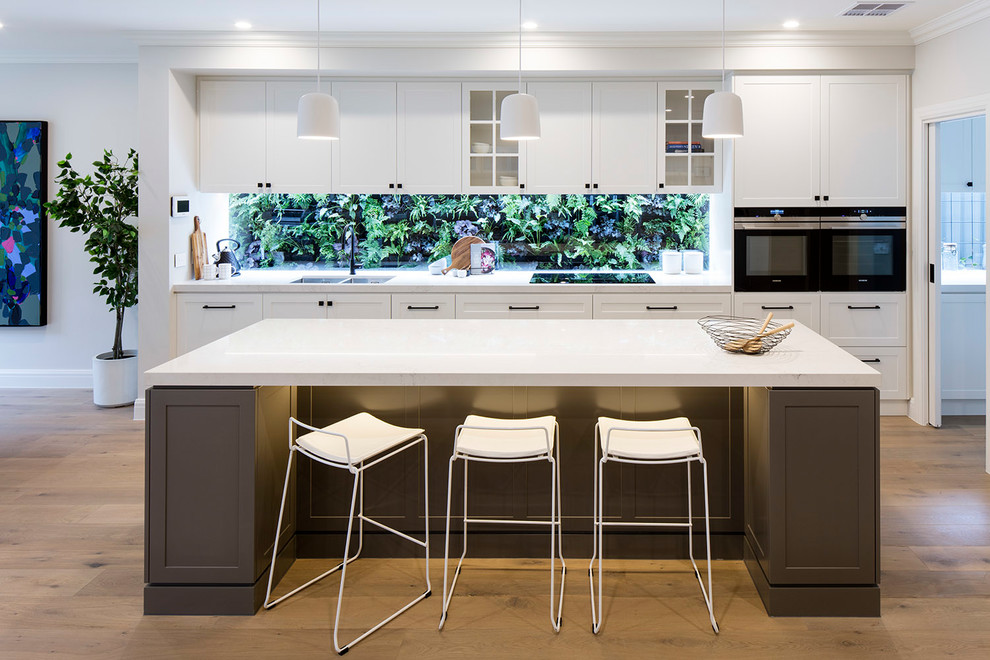 Inspiration for a transitional single-wall open plan kitchen in Melbourne with a double-bowl sink, shaker cabinets, white cabinets, window splashback, black appliances, dark hardwood floors, with island and brown floor.
