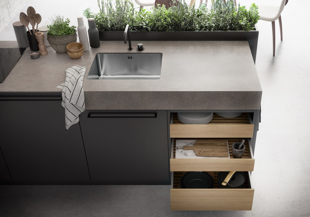 Ispirazione per una grande cucina design con ante lisce, top in superficie solida, elettrodomestici neri e pavimento in cemento