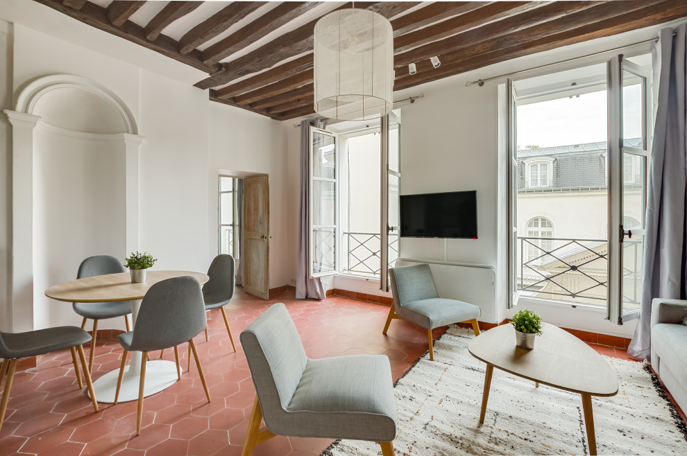 Inspiration for a scandinavian open concept living room in Paris with white walls, terra-cotta floors, no fireplace, a wall-mounted tv and red floor.
