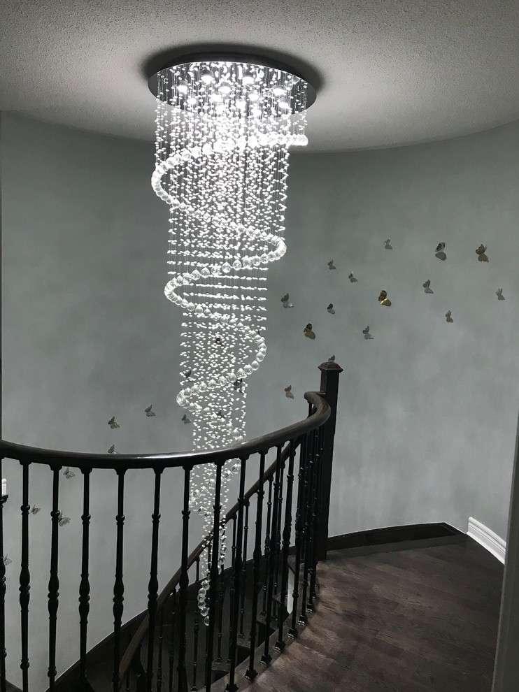 Example of a large transitional wooden curved wood railing staircase design in Toronto with wooden risers