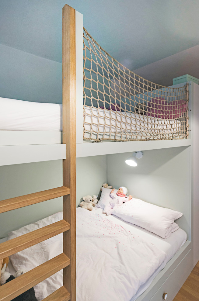 Example of a large trendy girl medium tone wood floor and brown floor childrens' room design in Other with green walls