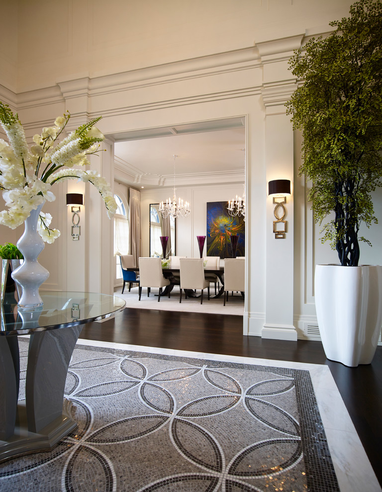 Inspiration for a large transitional marble floor foyer remodel in Toronto with white walls