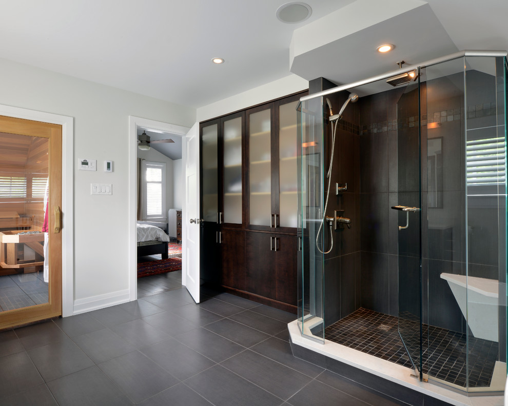 Large transitional master bathroom in Ottawa with glass-front cabinets, dark wood cabinets, white walls, porcelain floors, a freestanding tub and a corner shower.
