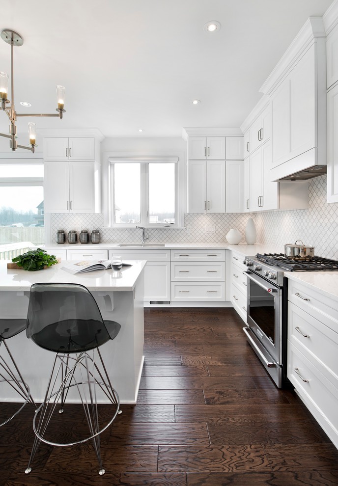 Design ideas for a large transitional l-shaped kitchen in Ottawa with an undermount sink, recessed-panel cabinets, white cabinets, granite benchtops, white splashback, mosaic tile splashback, stainless steel appliances, dark hardwood floors and with island.