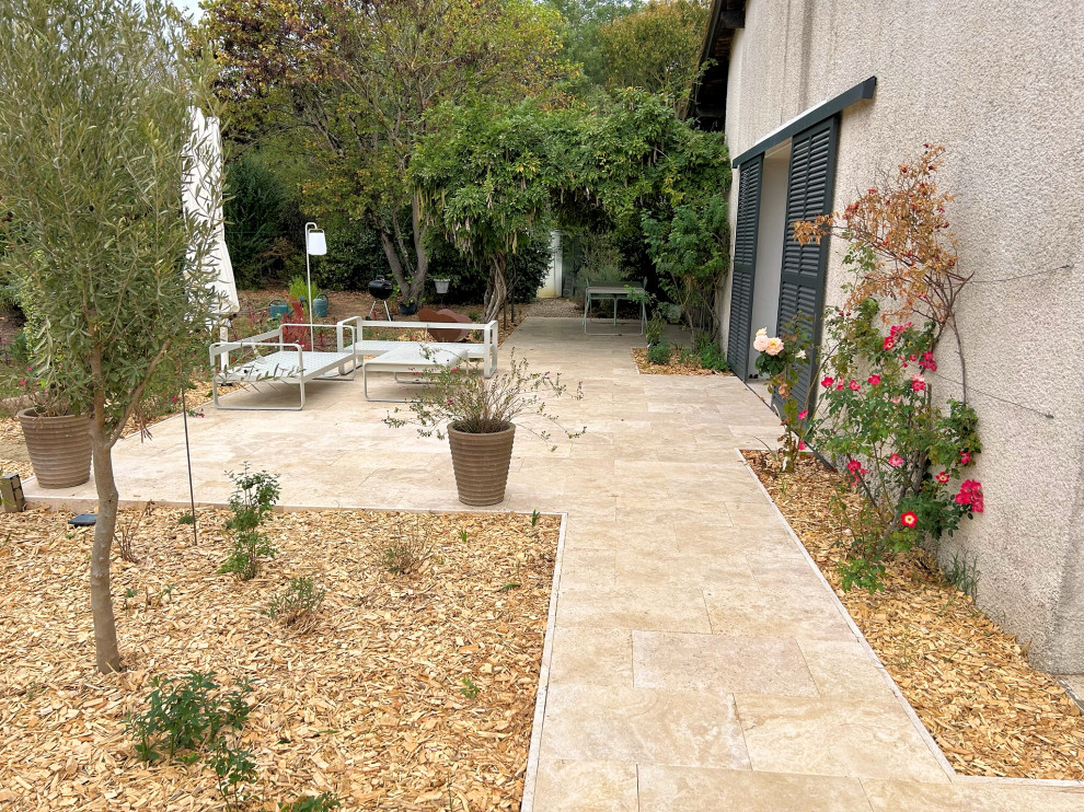 Patio - mid-sized farmhouse backyard tile patio idea in Toulouse