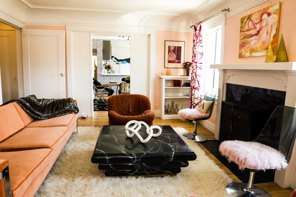 Design ideas for an eclectic living room in Los Angeles with pink walls.