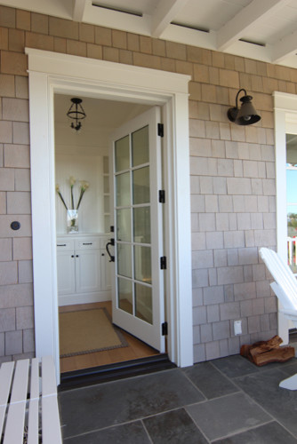 This is an example of a mid-sized beach style front door in Santa Barbara with grey walls, light hardwood floors, a single front door and a white front door.