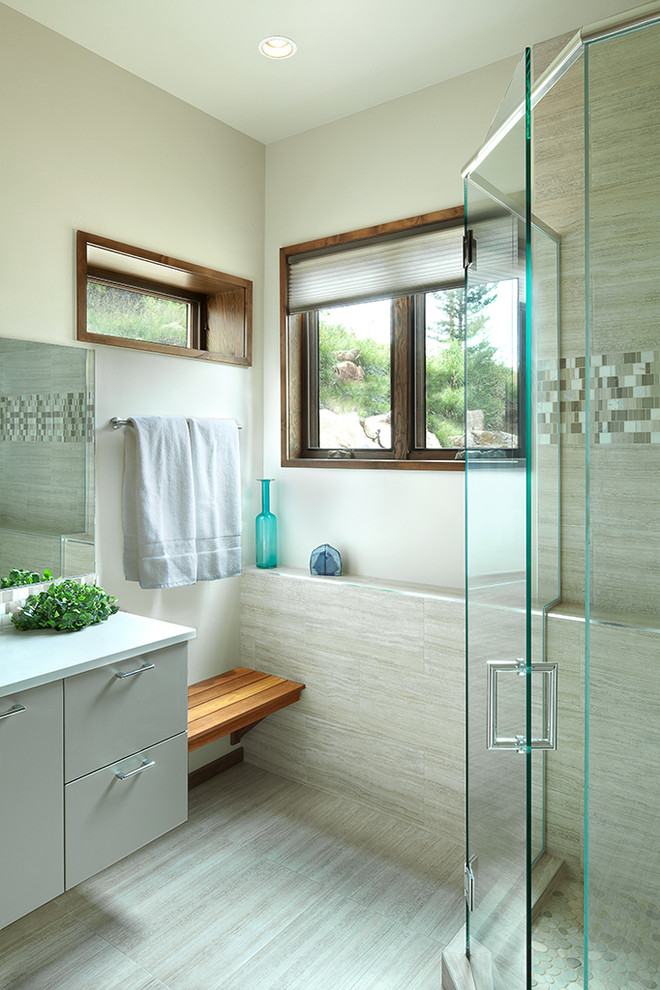 Design ideas for a large contemporary 3/4 bathroom in Albuquerque with an undermount sink, flat-panel cabinets, grey cabinets, quartzite benchtops, a corner shower, a one-piece toilet, gray tile, ceramic tile, grey walls and ceramic floors.