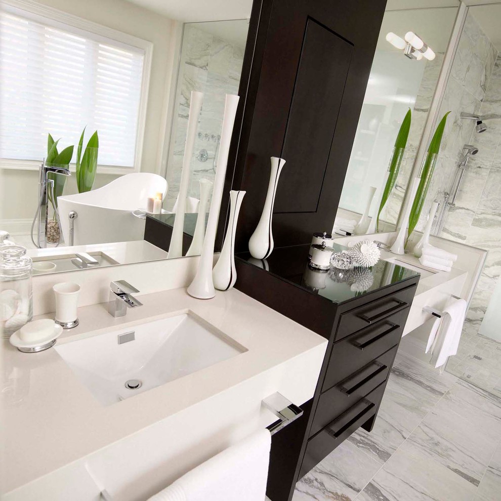 Mid-sized contemporary master bathroom in Toronto with flat-panel cabinets, dark wood cabinets, a freestanding tub, a curbless shower, white tile, stone tile, white walls, marble floors, an undermount sink and engineered quartz benchtops.