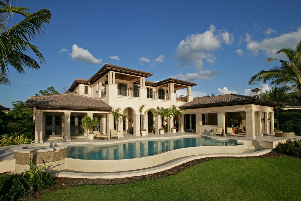 Inspiration for a mediterranean two-storey stucco beige exterior in Miami.
