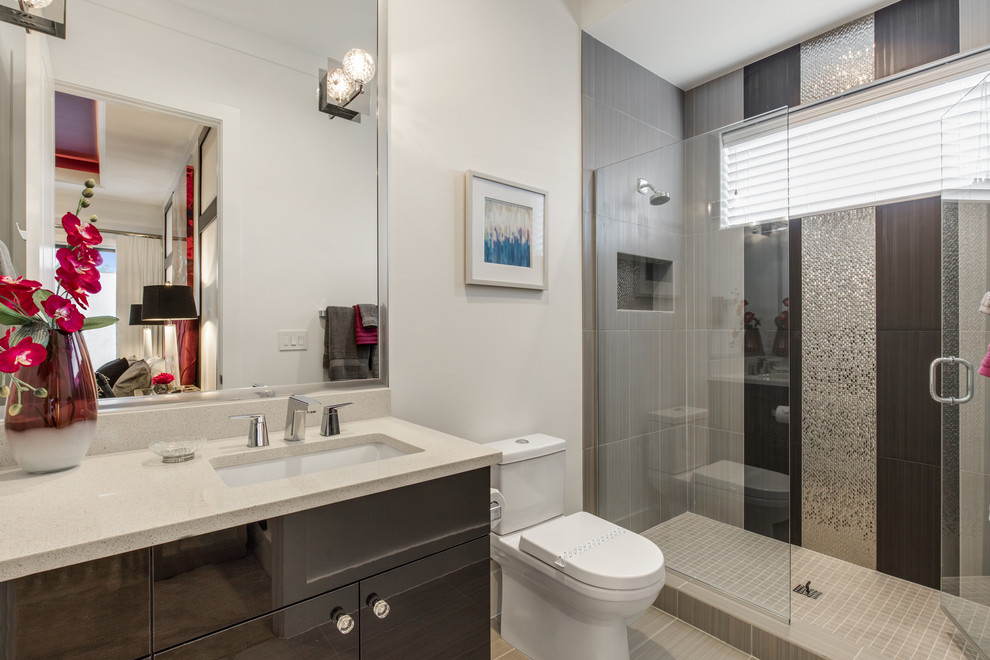 Photo of a mid-sized contemporary 3/4 bathroom in Orlando with flat-panel cabinets, dark wood cabinets, an alcove shower, a two-piece toilet, black and white tile, porcelain tile, white walls, porcelain floors, a drop-in sink and engineered quartz benchtops.