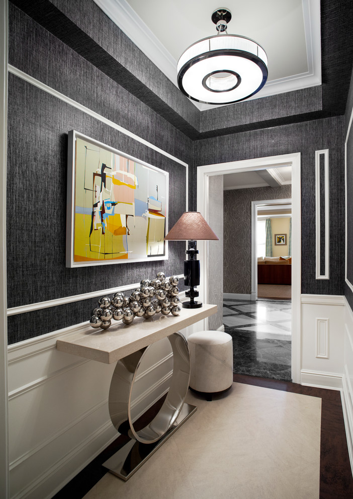 Photo of a transitional entry hall in New York with grey walls and dark hardwood floors.